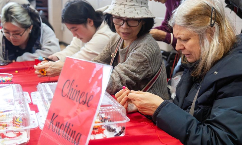 People learn to make Chinese knots in celebration of Chinese New Year at the Chinese Cultural Center of Greater Toronto in Toronto, Canada, Feb. 15, 2026. (Photo by Zou Zheng/Xinhua)