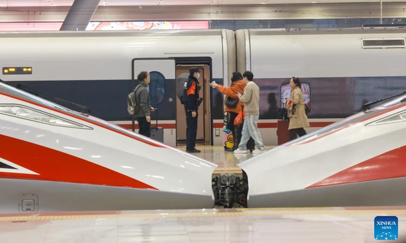 Passengers take a train at the Wuhan Railway Station in Wuhan, central China's Hubei Province, Feb. 15, 2026. Over 285 million inter-regional passenger trips are predicted across China on Sunday, the first day of this year's nine-day Spring Festival holiday. Photo: Xinhua