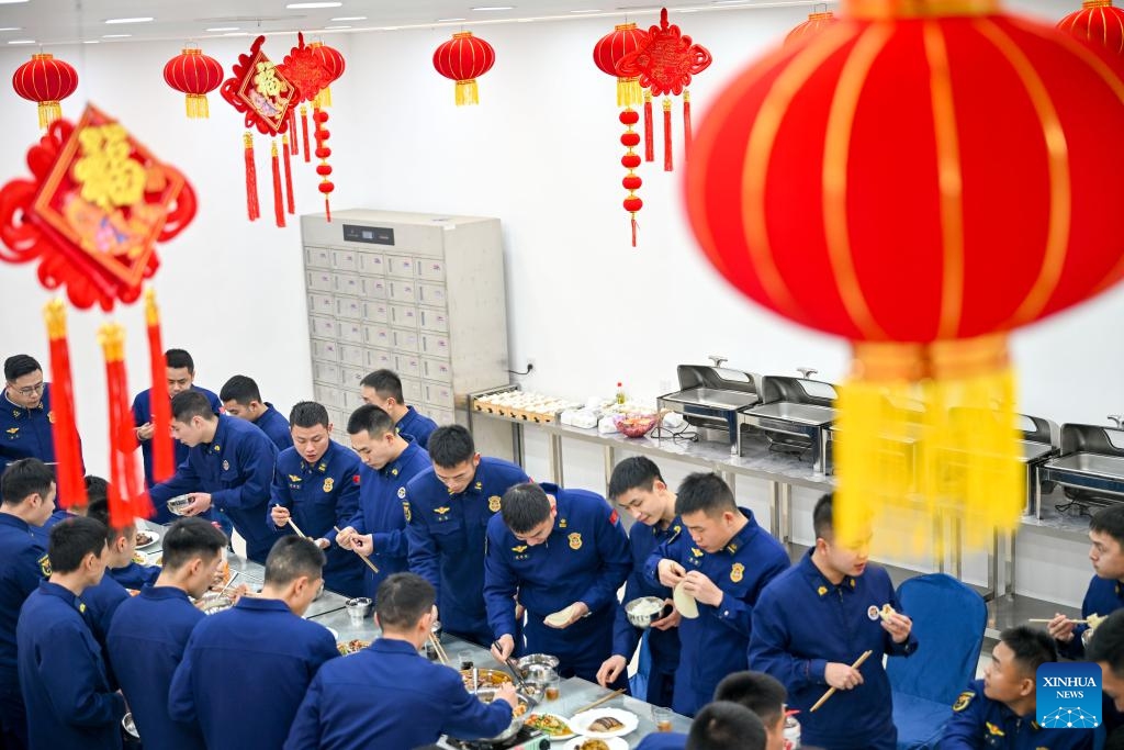 Firefighters enjoy the Chinese New Year's Eve dinner at a canteen in Kaiyang County, southwest China's Guizhou Province, Feb. 16, 2026. Chinese New Year's Eve is the most significant moment of Spring Festival celebrations when families and friends sit around the table to share delicious food and personal stories, and stay up to welcome the New Year. (Photo: Xinhua)