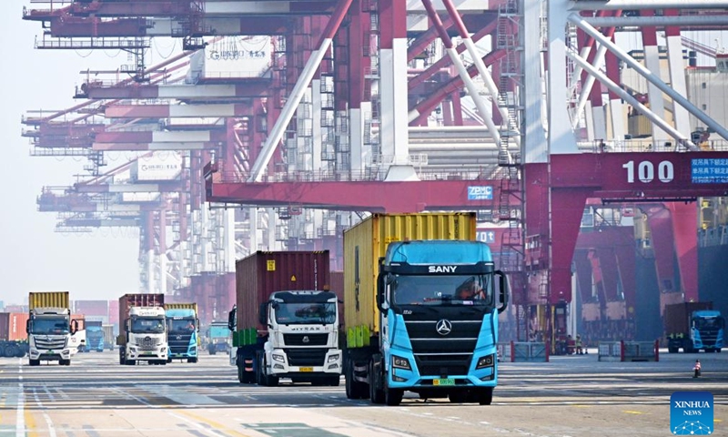 Trucks transport containers at Qianwan Container Terminal of Qingdao Port in Qingdao, east China's Shandong Province, Feb. 18, 2026. During the Spring Festival holiday, Qianwan Container Terminal of Qingdao Port has witnessed a bustling scene. Qingdao Port coordinated in advance to ensure operations during the festival, improving cargo transportation efficiency and optimizing the foreign trade port's business environment while prioritizing the work safety. (Xinhua/Li Ziheng)
