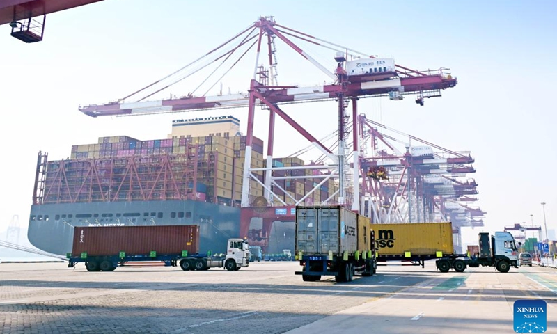 Trucks transport containers at Qianwan Container Terminal of Qingdao Port in Qingdao, east China's Shandong Province, Feb. 18, 2026. During the Spring Festival holiday, Qianwan Container Terminal of Qingdao Port has witnessed a bustling scene. Qingdao Port coordinated in advance to ensure operations during the festival, improving cargo transportation efficiency and optimizing the foreign trade port's business environment while prioritizing the work safety. (Xinhua/Li Ziheng)