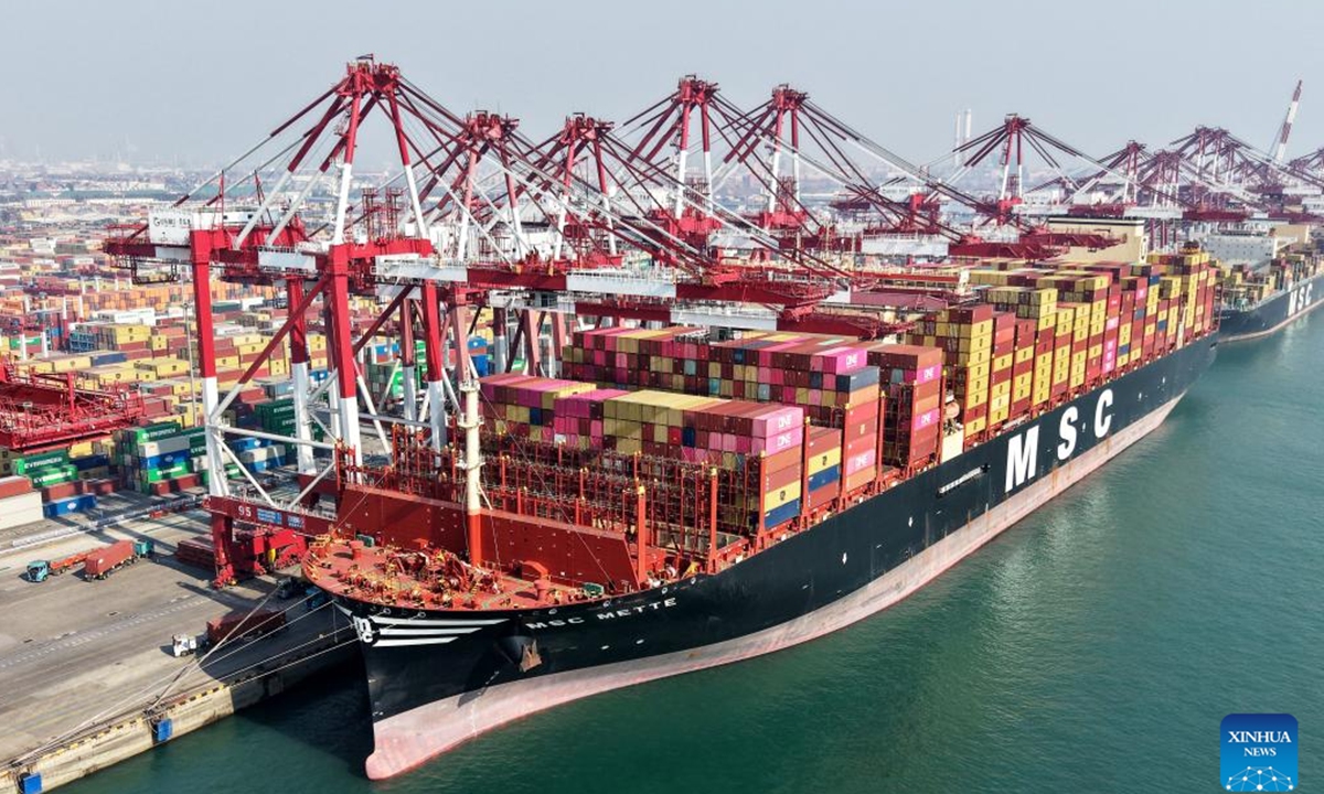 A drone photo taken on Feb. 18, 2026 shows a container vessel loading and unloading containers at Qianwan Container Terminal of Qingdao Port in Qingdao, east China's Shandong Province. During the Spring Festival holiday, Qianwan Container Terminal of Qingdao Port has witnessed a bustling scene. Qingdao Port coordinated in advance to ensure operations during the festival, improving cargo transportation efficiency and optimizing the foreign trade port's business environment while prioritizing the work safety. (Xinhua/Li Ziheng)