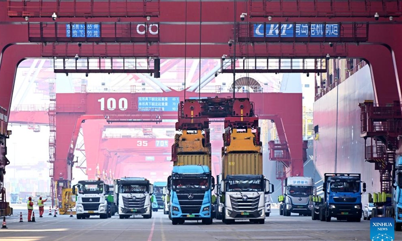 Trucks transport containers at Qianwan Container Terminal of Qingdao Port in Qingdao, east China's Shandong Province, Feb. 18, 2026. During the Spring Festival holiday, Qianwan Container Terminal of Qingdao Port has witnessed a bustling scene. Qingdao Port coordinated in advance to ensure operations during the festival, improving cargo transportation efficiency and optimizing the foreign trade port's business environment while prioritizing the work safety. (Xinhua/Li Ziheng)