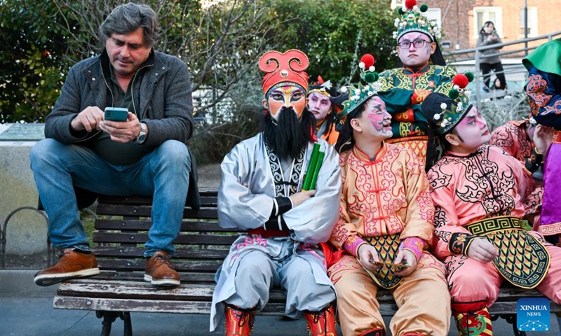 Yingge dancers from Guangdong Jieyang take a rest during a Spring Festival temple fair event in Madrid, Spain, Feb. 20, 2026. (Photo by Gustavo Valiente/Xinhua)