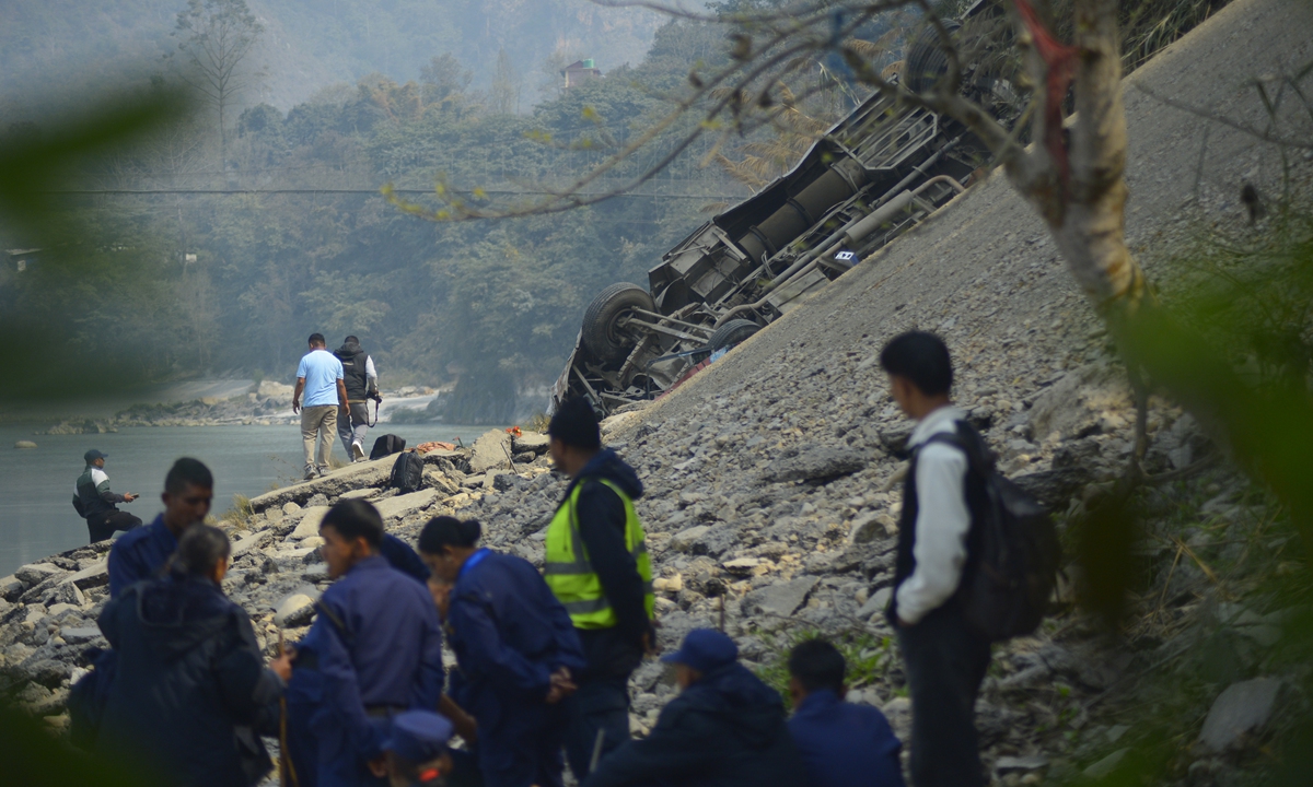 The wreckage of a bus is seen on the bank of the Trishuli River after it drove off a mountain highway near Benighat, west of the capital, Kathmandu, Nepal, on February 23, 2026. The Chinese Embassy in Nepal has confirmed that one Chinese national was killed and another injured. Photo: VCG