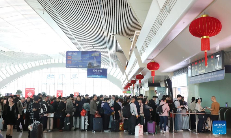 People queue up to check in at the waiting hall of Xiamen Railway Station in Xiamen, southeast China's Fujian Province, Feb. 14, 2026. (Photo by Zeng Demeng/Xinhua)