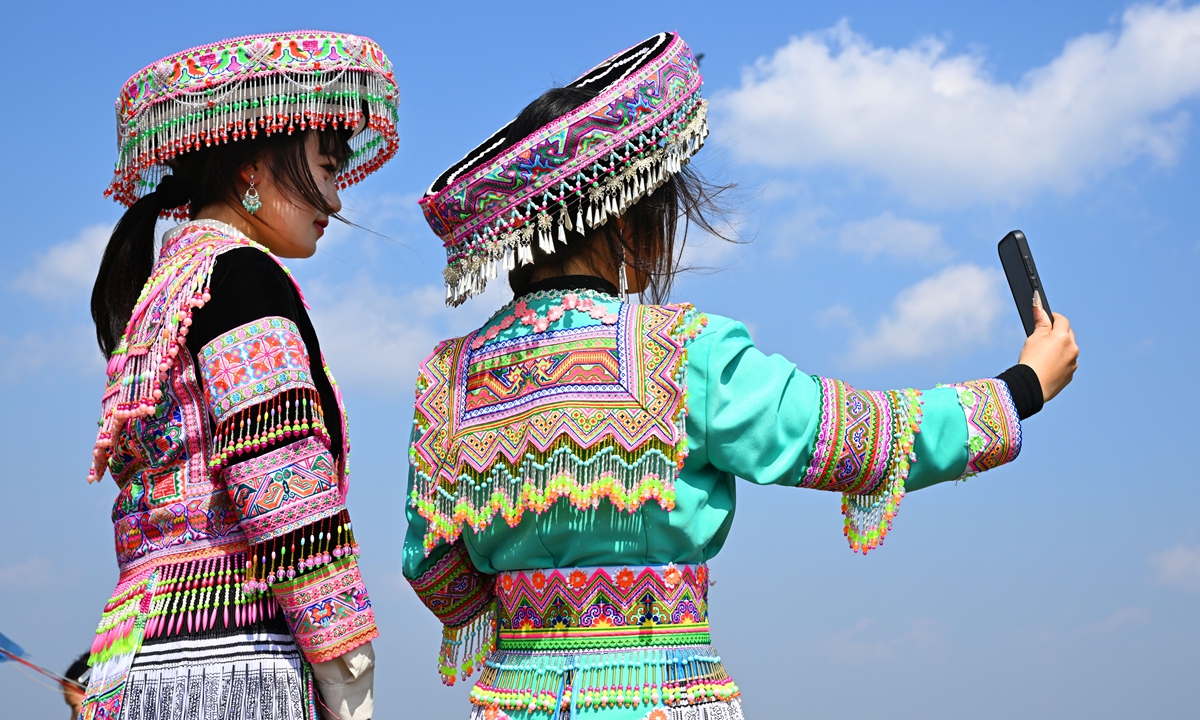 Two young women take a selfie on February 23, 2026 in the Tieshi Miao and Yi ethnic township in Qianxi county, Southwest China's Guizhou Province. More than 10,000 people gathered to celebrate the annual Flower Jumping Festival, a traditional folk activity of the local ethnic Miao people to celebrate the harvest. It is also an important event for young people to court each other and experience and inherit ethnic culture. Photo: VCG