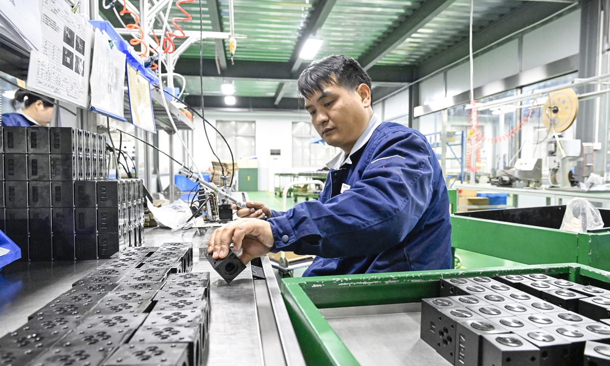 A worker processes electromagnetic valves for new-energy vehicles at a factory in Hefei, East China's Anhui Province, on February 24, 2026, the first working day after the Spring Festival holiday, as many local manufacturers resume operations early and run at full capacity to secure a strong start to the year. Photo: VCG