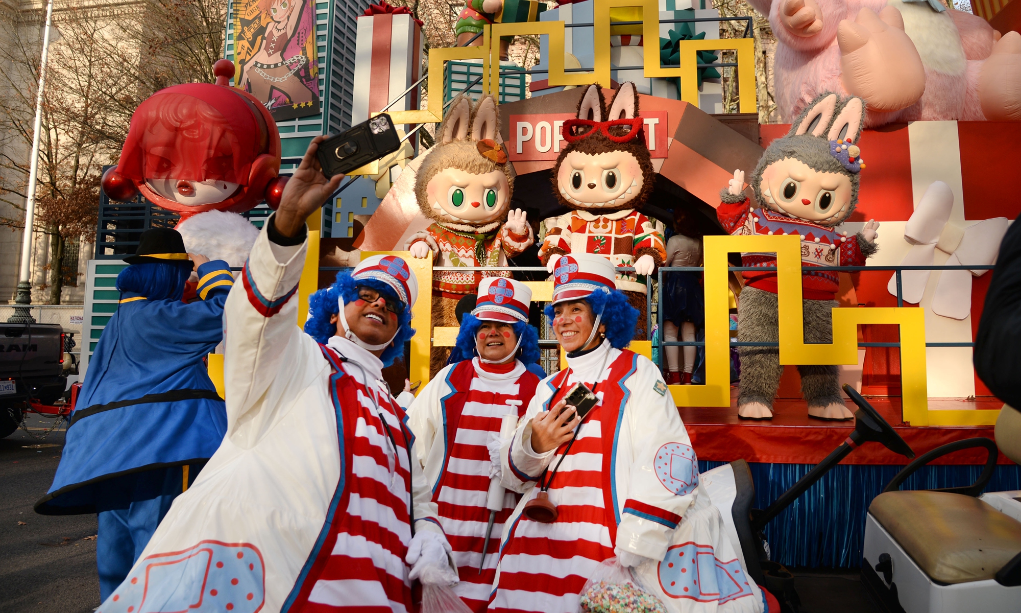 Performers pose for photos with Labubu figures during the 99th Macy's Thanksgiving Day Parade in New York, the US, on November 27, 2025. Photos on this page: VCG 