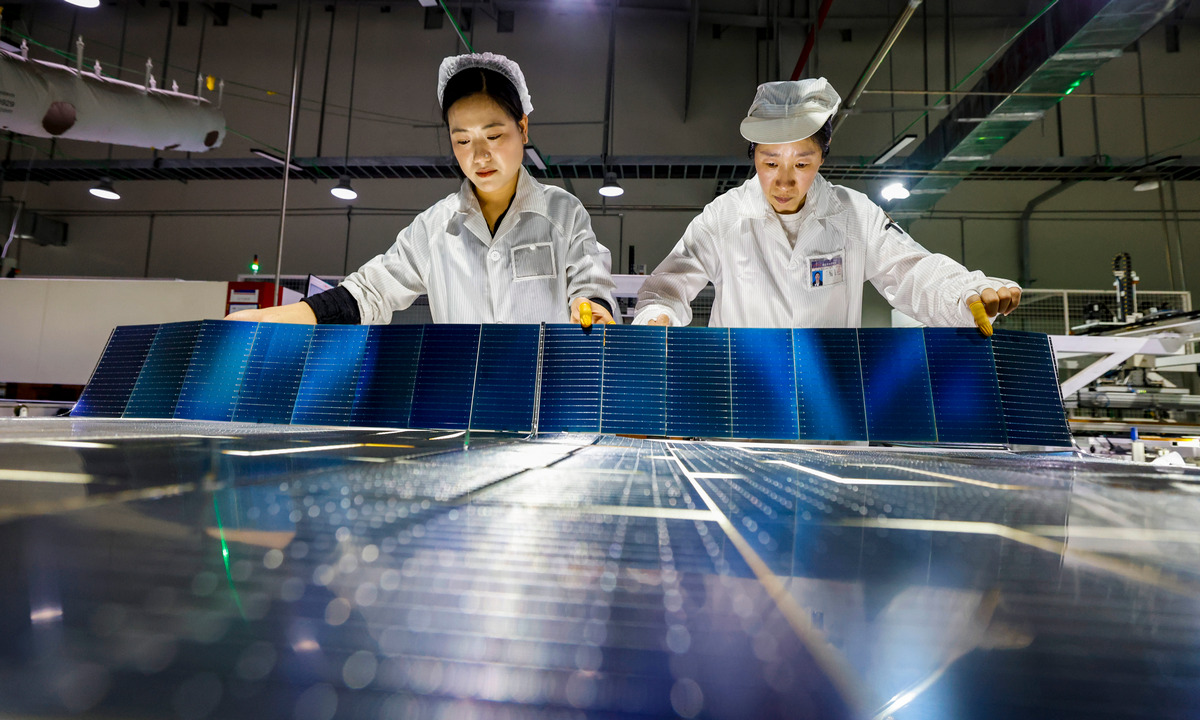 Workers rush to fill export orders for photovoltaic equipment in a new-energy technology company in Sihong, East China's Jiangsu Province on February 25, 2026. China's exports of new-energy products such as electric vehicles, photovoltaic products, and lithium batteries reached 1.3 trillion yuan ($189.24 billion) last year, customs data showed. Photo: VCG