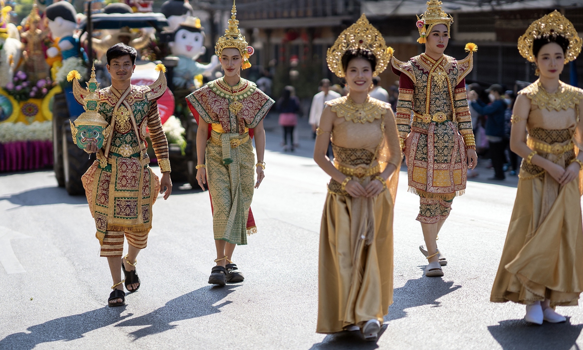 Participants wearing traditional Thai costumes walk in the floral parade during the 49th Chiang Mai Flower Festival parade in Chiang Mai on February 14, 2026. The annual festival features colorful street parade, cultural performances, and elaborate floral displays, drawing large numbers of residents and tourists to the city. Photo: VCG