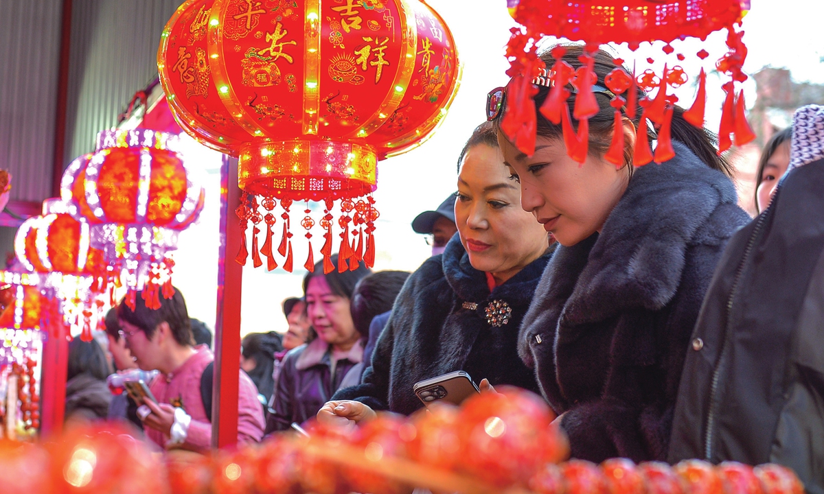 Visitors explore a food market in Qingdao's Shibei district on February 18, 2026.