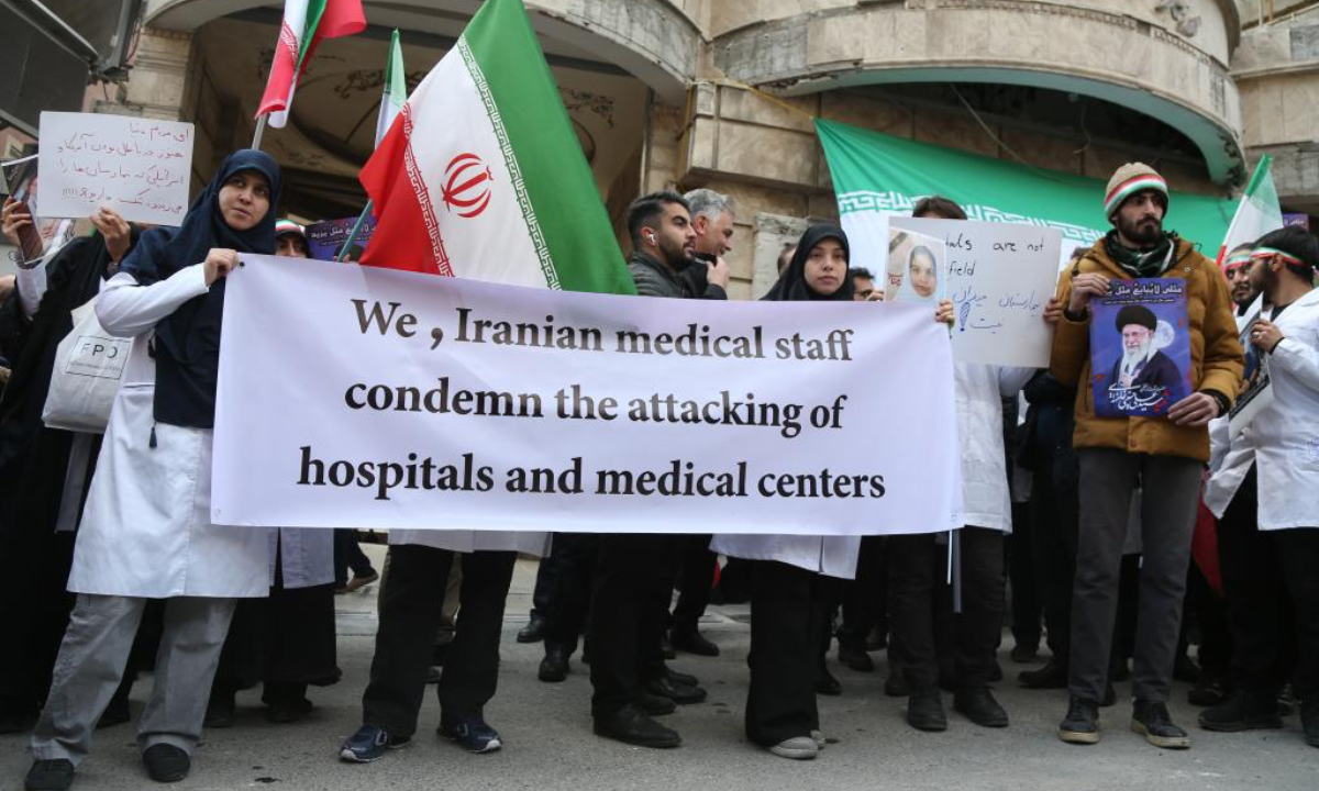 Medical workers participate in a rally in front of a hospital damaged in a U.S.-Israeli strike, in Tehran, Iran, March 7, 2026. (Xinhua/Shadati)