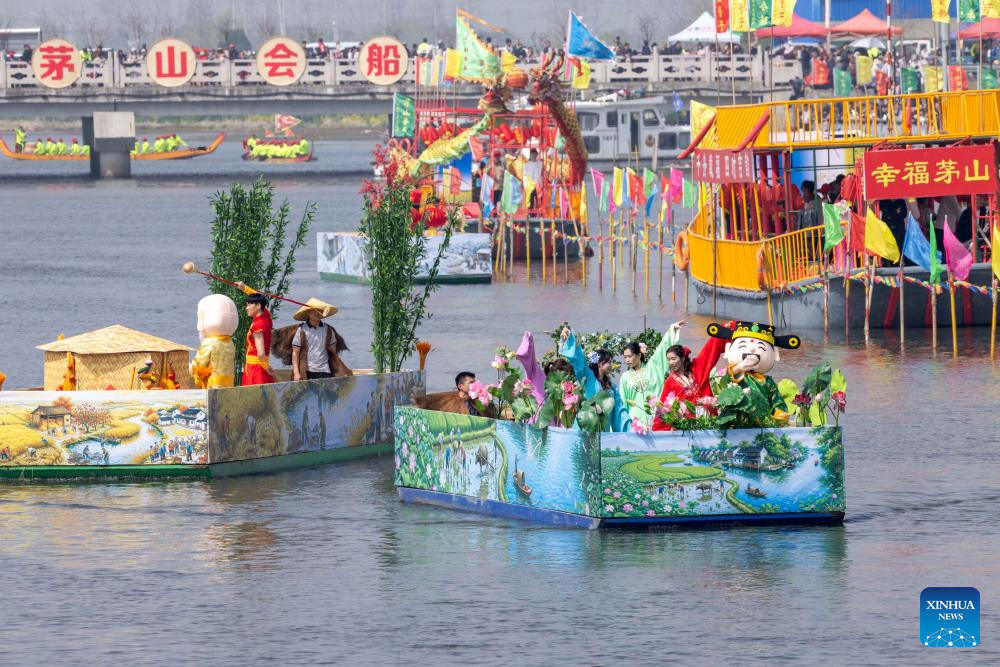 An aerial drone photo taken on April 5, 2026 shows boats sailing during the Maoshan boat fair in Xinghua City, east China's Jiangsu Province. The annual Maoshan boat fair in Xinghua was held on Sunday. The event was listed as a national intangible cultural heritage in 2014. (Photo by Shi Daozhi/Xinhua)