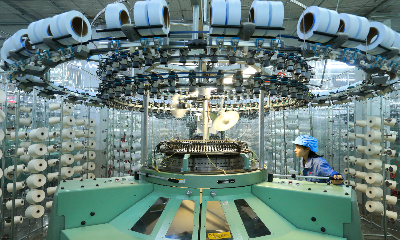 A worker produces fabric destined for overseas markets in Qingdao, East China's Shandong Province, on March 16, 2026. In recent years, Qingdao's Jimo District has promoted the textile and apparel industry toward scale, clustering, and high-end development. The district now hosts more than 3,800 textile and clothing enterprises, producing 800 million garments annually. Photo: VCG