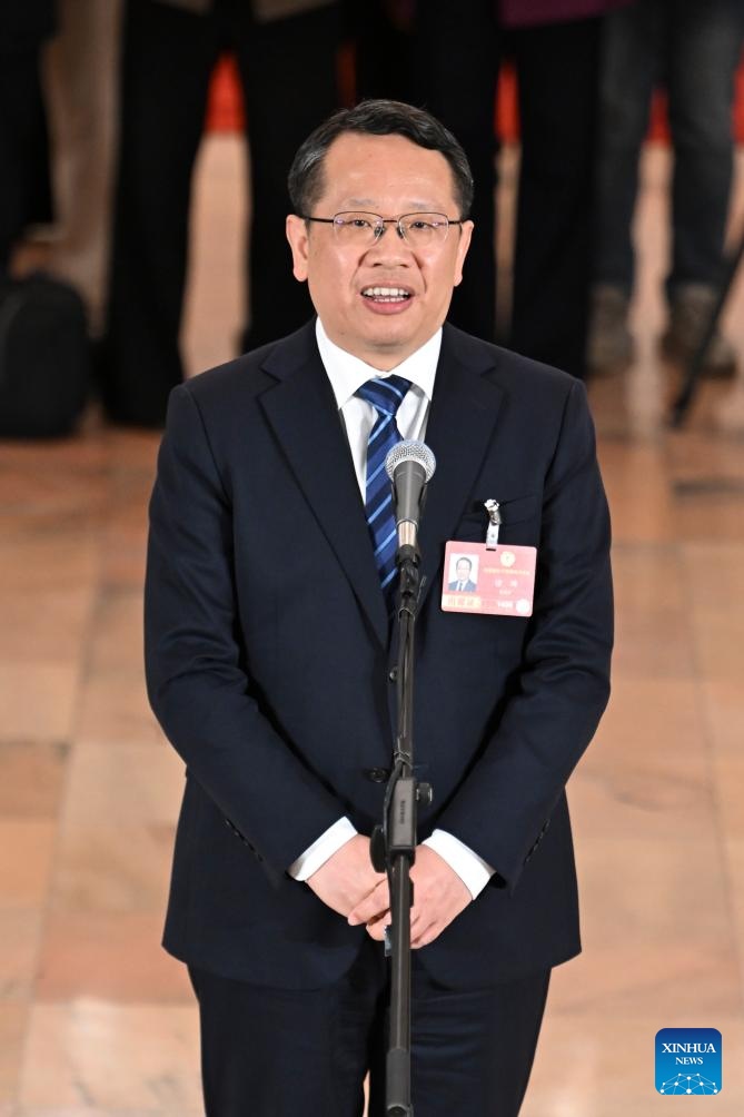 Xu Kun, a member of the 14th National Committee of the Chinese People's aPolitical Consultative Conference (CPPCC), attends a group interview ahead of the closing meeting of the fourth session of the 14th CPPCC National Committee at the Great Hall of the People in Beijing, capital of China, March 11, 2026. (Xinhua/Cao Yiming)