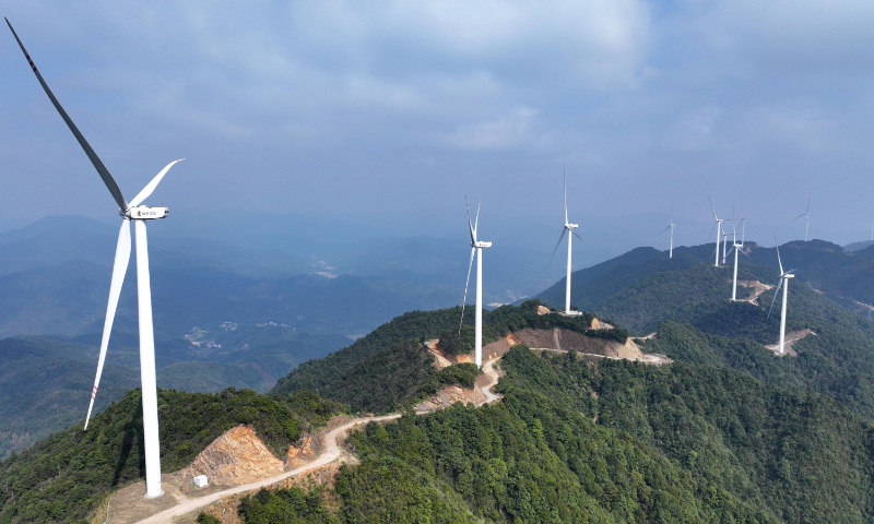 Wind turbines rotate atop the mountain peaks at a wind farm in Langchuan village, East China's Jiangxi Province, on March 6, 2026. Photo: VCG