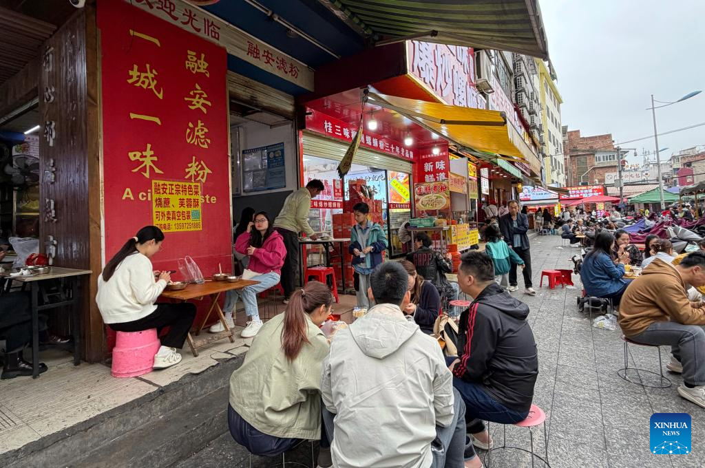 People enjoy Lyufen at an eatery in Liuzhou City, south China's Guangxi Zhuang Autonomous Region, March 28, 2026. In Guangxi, rice noodles are served in many different ways, such as Luosifen, Guilin rice noodles, seafood rice noodles, Nanning Laoyou rice noodles and Shengzha rice noodles, with noodle shops found everywhere from busy streets to small lanes. (Photo by Zheng Changhao/Xinhua)