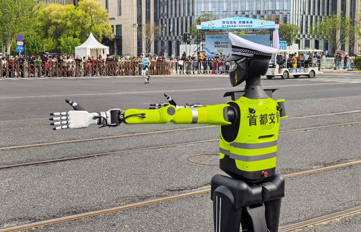 A traffic police robot is seen directing traffic at the second humanoid robot half-marathon run held in Yizhuang, Beijing, on April 19, 2026. Photo: CMG