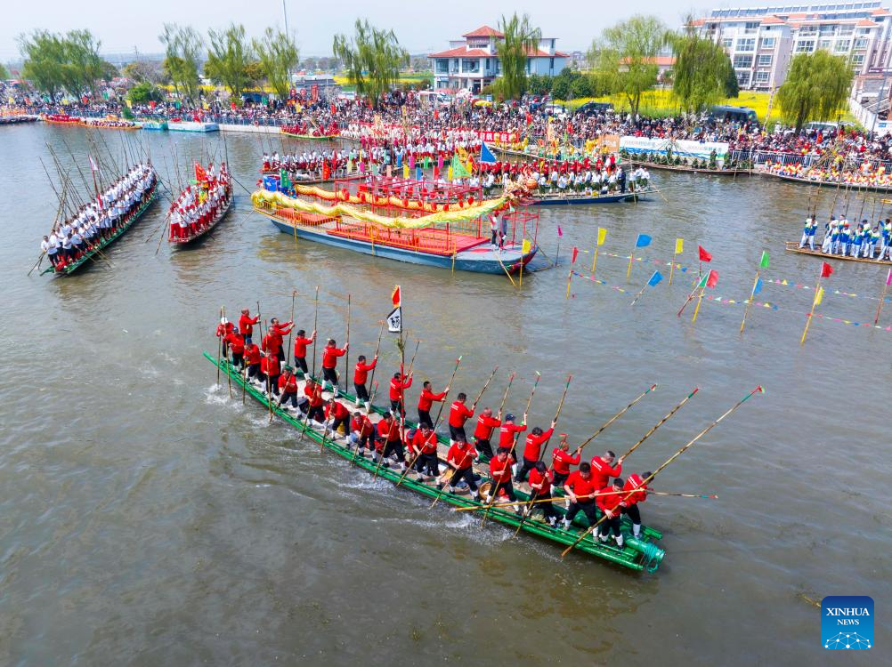 An aerial drone photo taken on April 5, 2026 shows boats sailing during the Maoshan boat fair in Xinghua City, east China's Jiangsu Province. The annual Maoshan boat fair in Xinghua was held on Sunday. The event was listed as a national intangible cultural heritage in 2014. (Photo by Shi Daozhi/Xinhua)