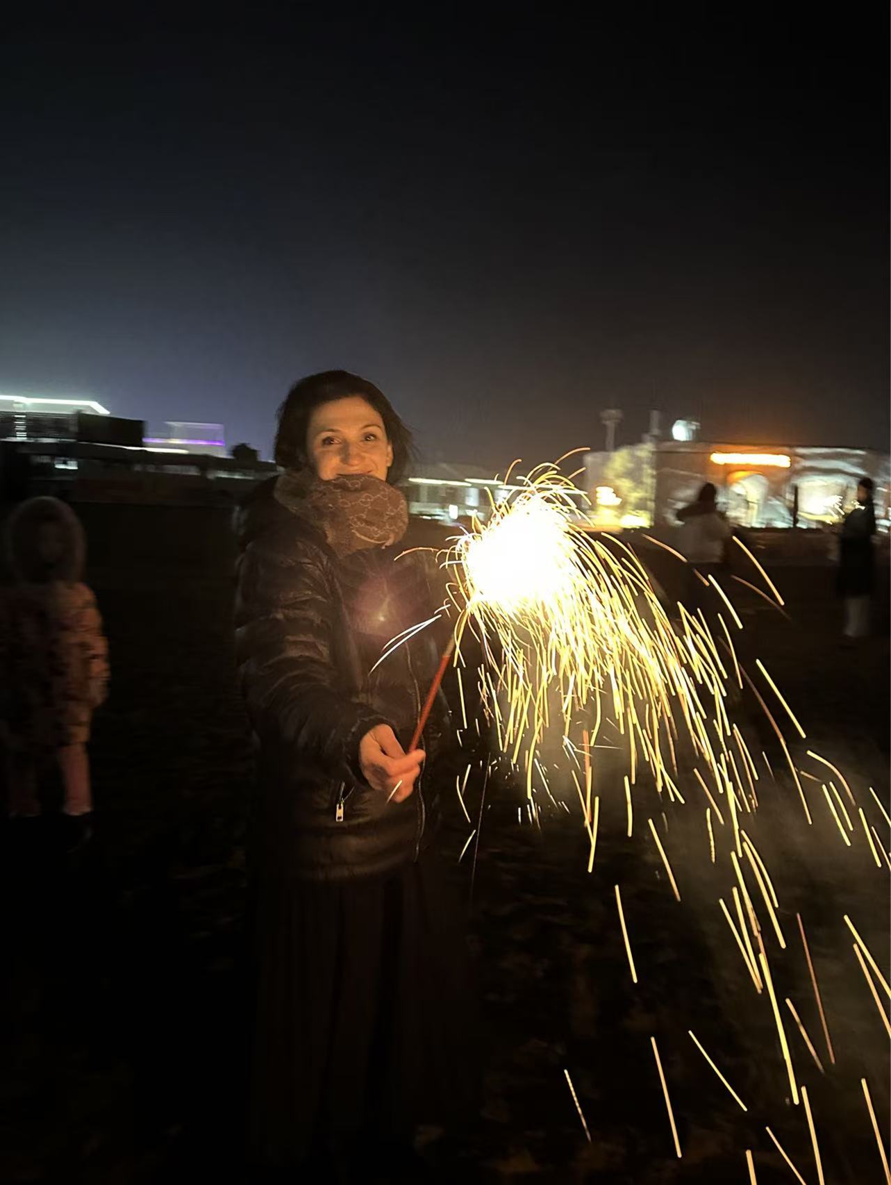 Andreea-Ema Stoian enjoys fireworks by the seashore in Rizhao, East China's Shandong Province, on February 14, 2026.