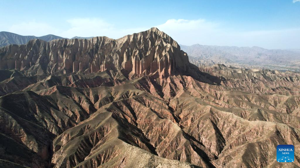 This aerial drone photo taken on April 4, 2026 shows a view of the Shilaquan Canyon in Tangwang Town of Dongxiang Autonomous County, Linxia Hui Autonomous Prefecture, northwest China's Gansu Province. Shilaquan Canyon has an average elevation of approximately 2,000 meters. The red sandstone and gravel layers on both sides of the canyon have been shaped by water erosion and wind abrasion, forming a distinctive Danxia landform. (Xinhua/Chen Bin)