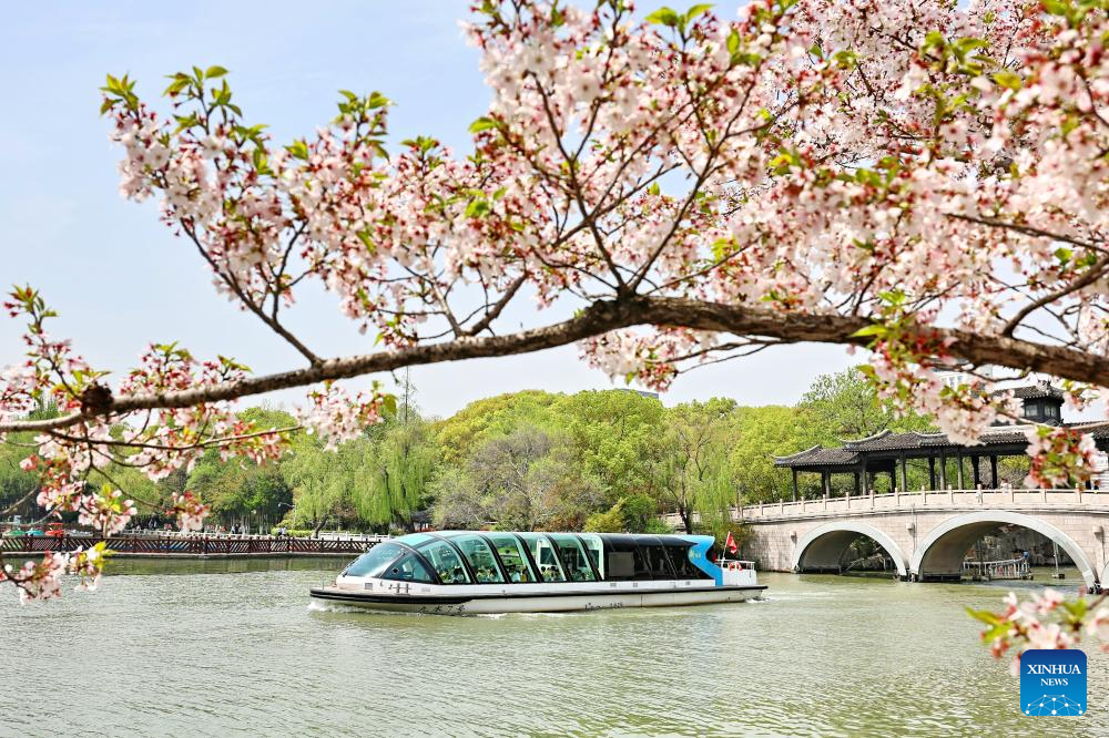 Tourists enjoy the scenery during a boat ride at a scenic area in Jiaxing, east China's Zhejiang Province, April 5, 2026. Qingming Festival, or Tomb-Sweeping Day, falls on April 5 this year. It is a traditional Chinese festival for people to pay tribute to the dead and worship their ancestors. The holiday also provides a short break for Chinese citizens as they engage in outdoor activities and sightseeing. (Photo by Jin Peng/Xinhua)