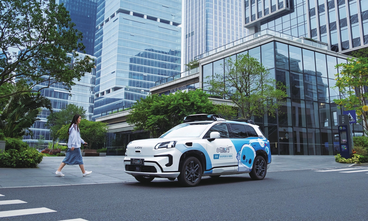 A passenger walks to a Pony.ai robotaxi in Shenzhen, South China's Guangdong Province, during the 2026 Spring Festival holiday. Photo: Courtesy of Pony.ai