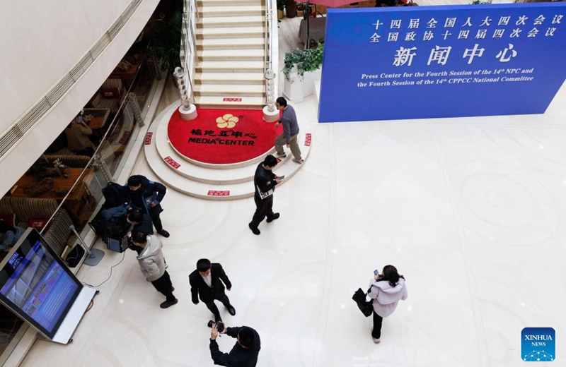 Staff members and journalists work at a press center for China's annual two sessions in Beijing, capital of China, Feb. 27, 2026. A press center for China's annual sessions of its top legislature and political advisory body, known as the two sessions, opened on Friday at the Media Center Hotel in Beijing. (Xinhua/Jin Liwang)
