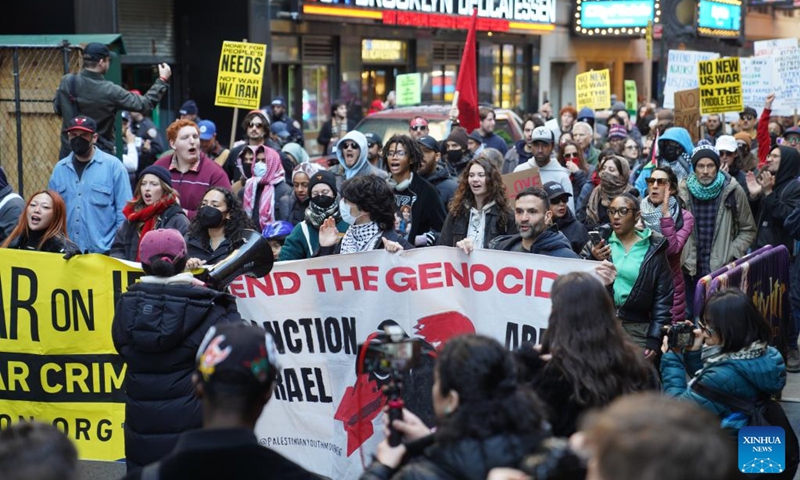 People attend a protest against U.S.-Israeli attacks on Iran, in New York, the United States, on Feb. 28, 2026.Hundreds of New Yorkers rallied in Times Square and then marched along streets in New York City in protest of U.S.-Israel coordinated airstrikes against Iran on Saturday. (Xinhua/Zhang Fengguo)