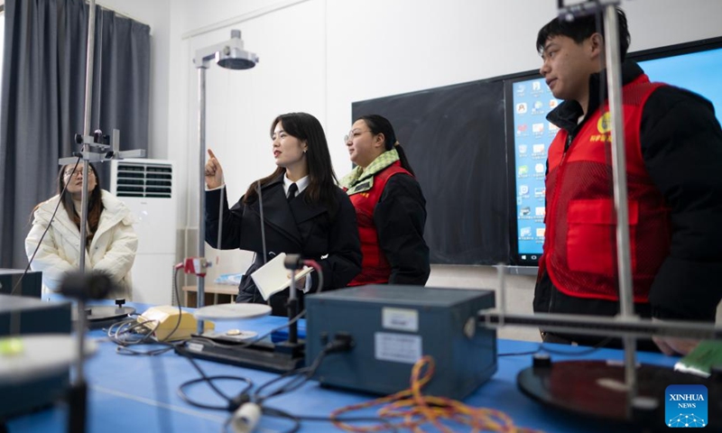 Zhang Qiongli (2nd L) talks with members of science volunteer service team from the Physics Department of Hubei Minzu University in Enshi Tujia and Miao Autonomous Prefecture, central China's Hubei Province, Feb. 4, 2026. Zhang, in cooperation with the team, actively carries out science popularization plus ideological and political education activities targeting teachers and students from primary, secondary, and higher education institutions. Photo: Xinhua