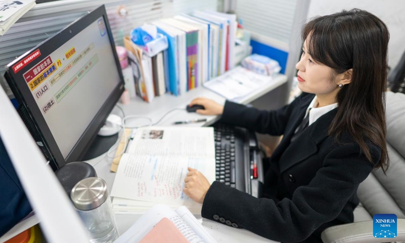 Zhang Qiongli works at her office at Enshi Tujia and Miao Autonomous Prefecture Senior High School in Enshi, central China's Hubei Province, Feb. 3, 2026. Photo: Xinhua