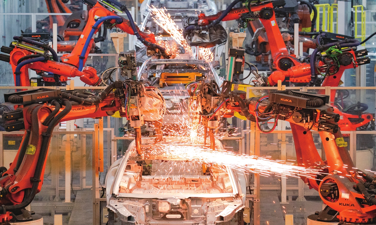 Robots perform welding operations at the BAIC New Energy Super Factory in Beijing on December 12, 2025. Photo: VCG