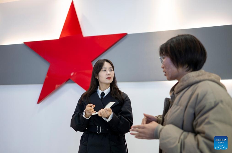 Zhang Qiongli communicates with a docent at an exhibition hall of the Communist Party of China in Enshi Tujia and Miao Autonomous Prefecture, central China's Hubei Province, Feb. 4, 2026. Photo: Xinhua