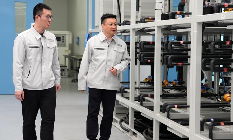 Zhang Fan (R) inspects a research base of China Electrical Equipment Group in Shanghai, east China, Jan. 27, 2026.

Zhang Fan is vice general manager of China Electrical Equipment Group and a deputy to the National People's Congress (NPC). Zhang believes that artificial intelligence (AI) plus manufacturing would be achieved through strengthening top-level design and industry guidelines. Last year, Zhang presented a suggestion on deepening integration of manufacturing and AI to promote high-quality innovative development. His suggestion was given great importance.

In January 2026, eight departments of China including the Ministry of Industry and Information Technology jointly issued a plan which outlines an ambitious push to deeply integrate AI with the manufacturing sector, foster new quality productive forces and comprehensively empower new industrialization.

Zhang stated that he will continue to concentrate on issues about the bottlenecks of data sharing in AI-driven manufacturing sector and successful experiences of leading enterprises. Photo: Xinhua