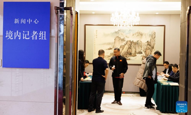 Journalists claim press cards at a press center for China's annual two sessions in Beijing, capital of China, Feb. 27, 2026. A press center for China's annual sessions of its top legislature and political advisory body, known as the two sessions, opened on Friday at the Media Center Hotel in Beijing. (Xinhua/Jin Liwang)