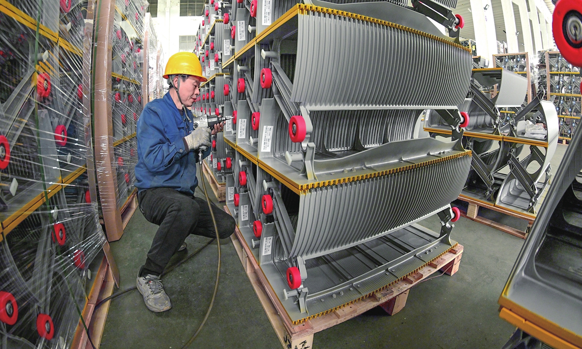 A worker produces customized escalator steps at Nantong Jiangzhong Photoelectricity Co, a national-level 