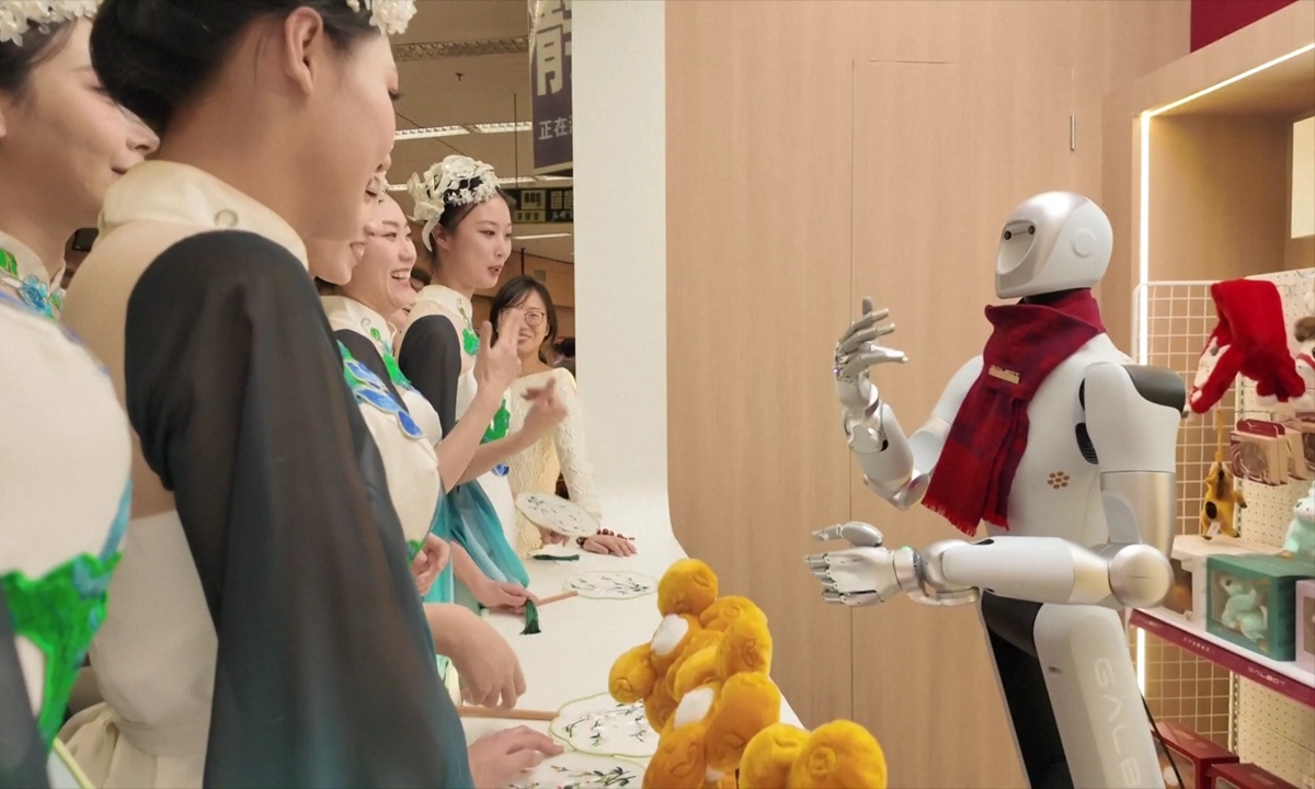 A Galbot robot interacts with dancers during a performance at the 2026 Spring Festival Gala on February 16, 2026. Photo: VCG