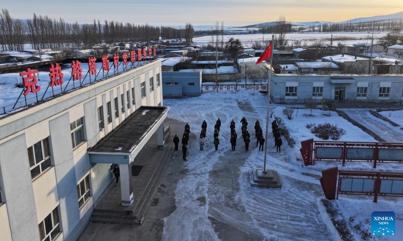 An aerial drone photo taken on Feb. 9, 2026 shows Musajan Khairat attending a national flag-raising ceremony at the community service center in Keregetas Village, Xinyuan County of Ili Kazak Autonomous Prefecture, northwest China's Xinjiang Uygur Autonomous Region, Feb. 9, 2026. Photo: Xinhua