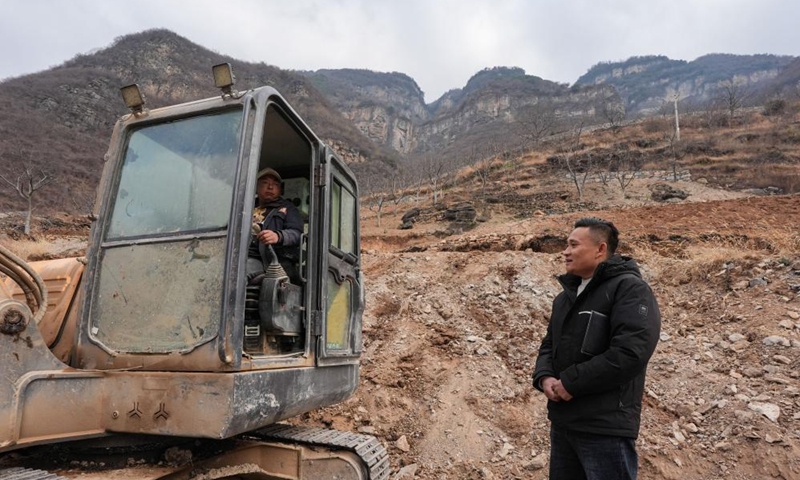 Zheng Wangchun (R) learns about the progress on village road construction in Gulu Village of Hanyuan County, southwest China's Sichuan Province, Jan. 29, 2026. Photo: Xinhua