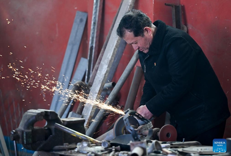 Musajan Khairat welds at his workshop in Keregetas Village, Xinyuan County of Ili Kazak Autonomous Prefecture, northwest China's Xinjiang Uygur Autonomous Region, Feb. 9, 2026. Photo: Xinhua
