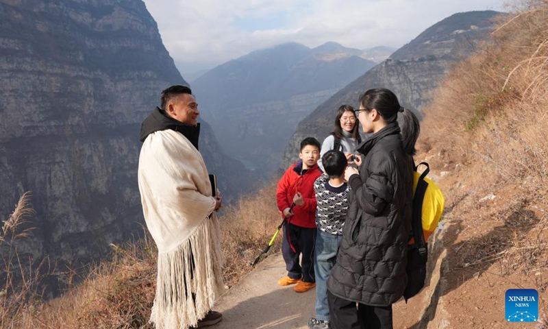 Zheng Wangchun (1st L) talks with tourists from Chongqing about their experience in Gulu Village of Hanyuan County, southwest China's Sichuan Province, Jan. 29, 2026. Photo: Xinhua