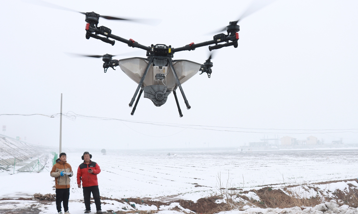 Two workers use a drone to fertilize wheat fields in Anyang, Central China's Henan Province, on March 3, 2026. Official data showed that in 2025, the annual output value of the Anyang Drone Industrial Park exceeded 1.3 billion yuan ($180 million), up more than 30 percent year-on-year. Photo: VCG