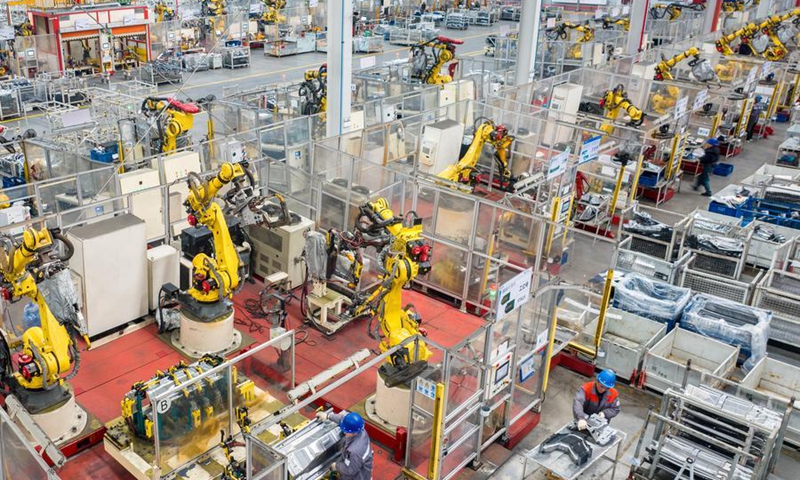 Technicians operate robotic arms to process components for new energy vehicles at a company in Changxing Economic and Technological Development Zone of Huzhou City, east China's Zhejiang Province, on Feb. 5, 2025. Photo: Xinhua