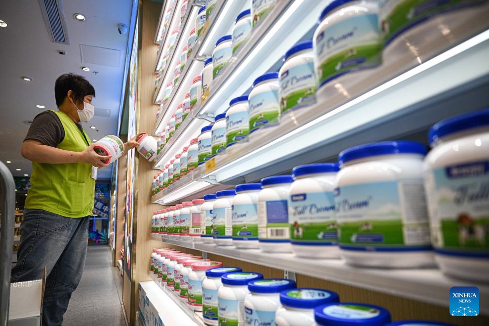 A staff member arranges milk powder at a duty-free grocery in Haikou, south China's Hainan Province, March 12, 2026. Since the zero-tariff policy on imported goods for Hainan Free Trade Port (FTP) residents took effect one month ago, duty-free sales have reached 5.37 million yuan (approximately 778,700 U.S. dollars), with 28,000 shopping visits recorded between Feb. 11 and March 10, according to Haikou Customs. (Xinhua/Pu Xiaoxu)

