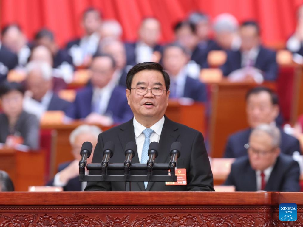 He Baoxiang delivers a report on how the proposals from political advisors have been handled since the third session of the 14th Chinese People's Political Consultative Conference (CPPCC) National Committee on behalf of the Standing Committee of the CPPCC National Committee at the opening meeting of the fourth session of the 14th CPPCC National Committee at the Great Hall of the People in Beijing, capital of China, March 4, 2026. (Xinhua/Liu Weibing)