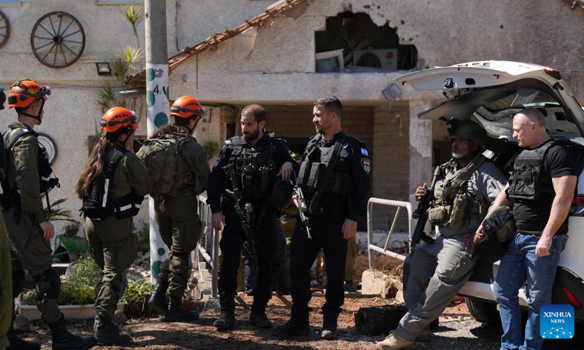 Israeli security personnel operate at a house affected during attacks in Moshav Kfar Yuval in northern Israel, near the border with southern Lebanon, on March 3, 2026. Hezbollah said on Tuesday that it launched a rocket barrage toward northern Israel in response to what it described as ongoing Israeli attacks on Lebanese areas. (Ayal Margolin/JINI via Xinhua)