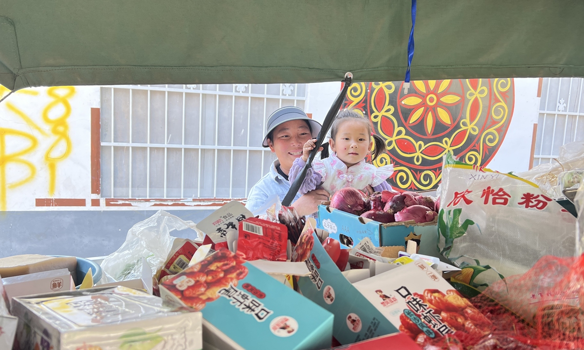 A mother and her daughter choose snacks in the peddler's cart in Abuluoha village on February 26, 2026. Photo: Leng Shumei/GT