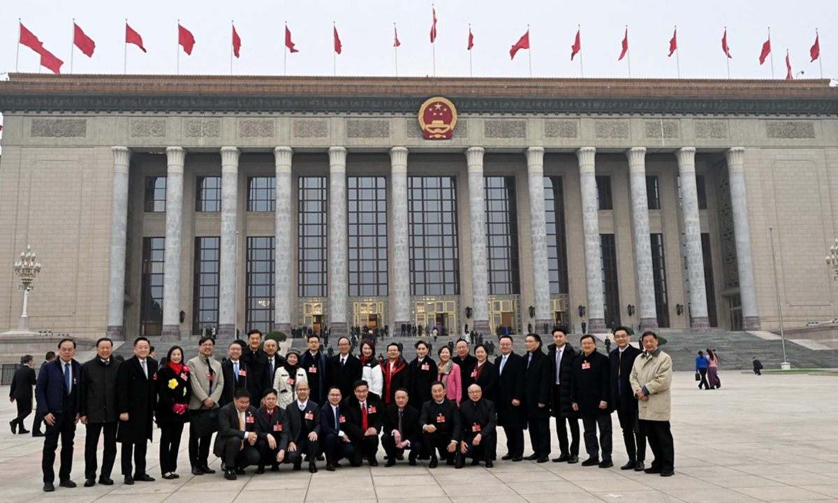 A delegation of deputies to the 14th National People's Congress from the Hong Kong Special Administrative Region (HKSAR) pose for a group photo in front of the Great Hall of the People before the opening meeting of the fourth session of the 14th CPPCC National Committee on March 4, 2026. Photo: Courtesy of the delegation 