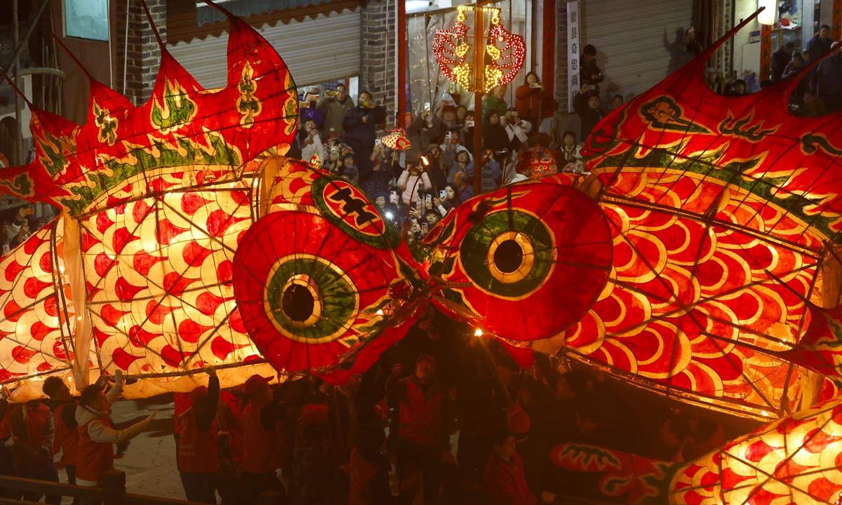 A performance team parades through Wangmantian village in East China's Anhui Province carrying fish-shaped lanterns, an intangible cultural heritage, to pray for a good harvest and good fortune on March 4, 2026. Photo: VCG